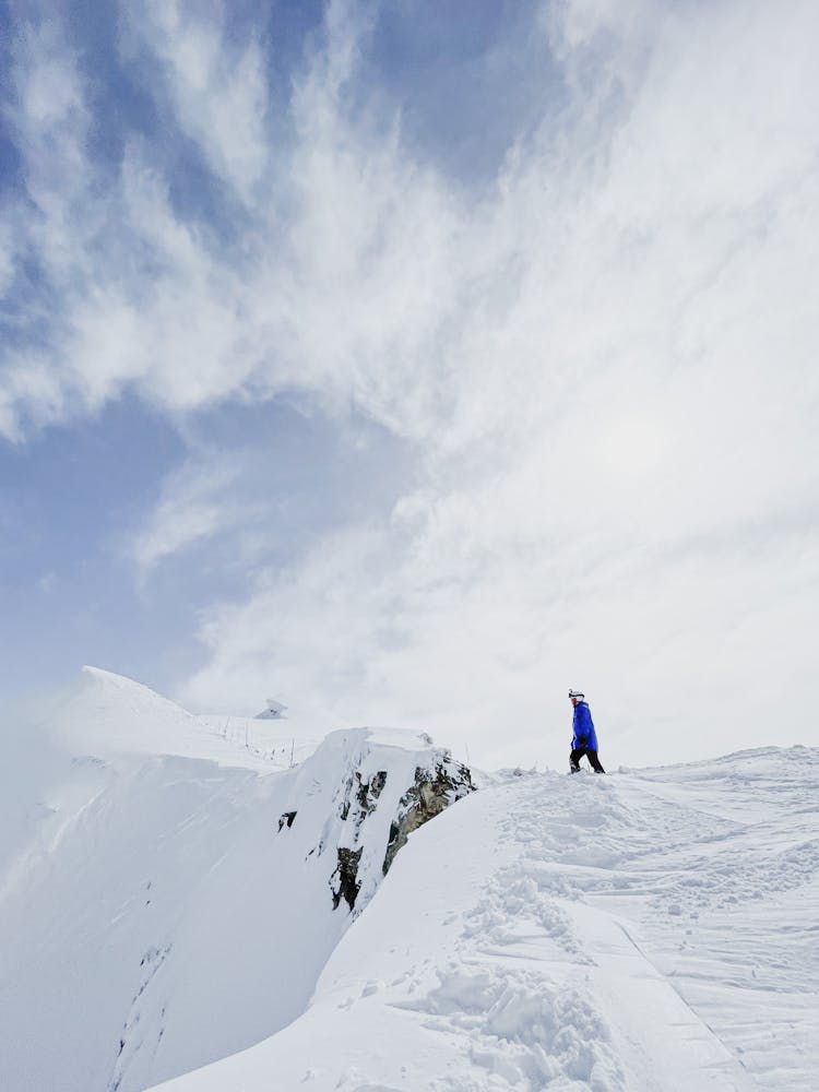 Skier On Top Of A Snow Covered Mountain