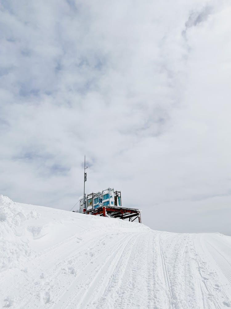 Building On Top Of A Snow Covered Mountain