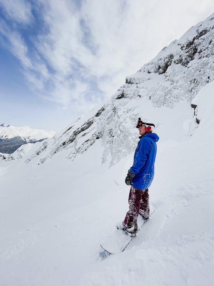 Man In A Blue Jacket Snowboarding