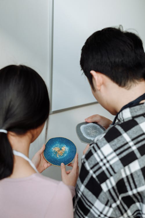 
A Couple Holding Resin Coasters