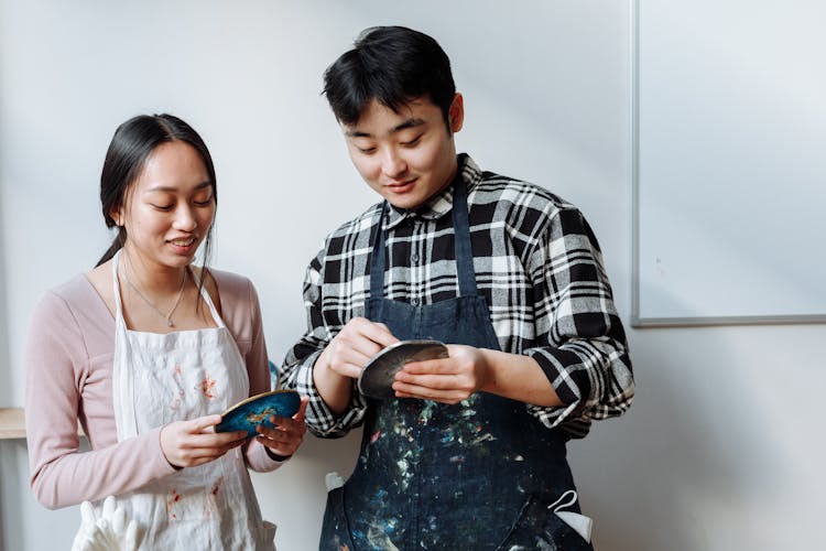 
A Couple Holding Resin Coasters