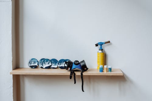 
A Blow Torch and a Respirator on a Wooden Shelf