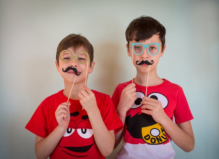 Young Males With Prop Glasses And Mustache