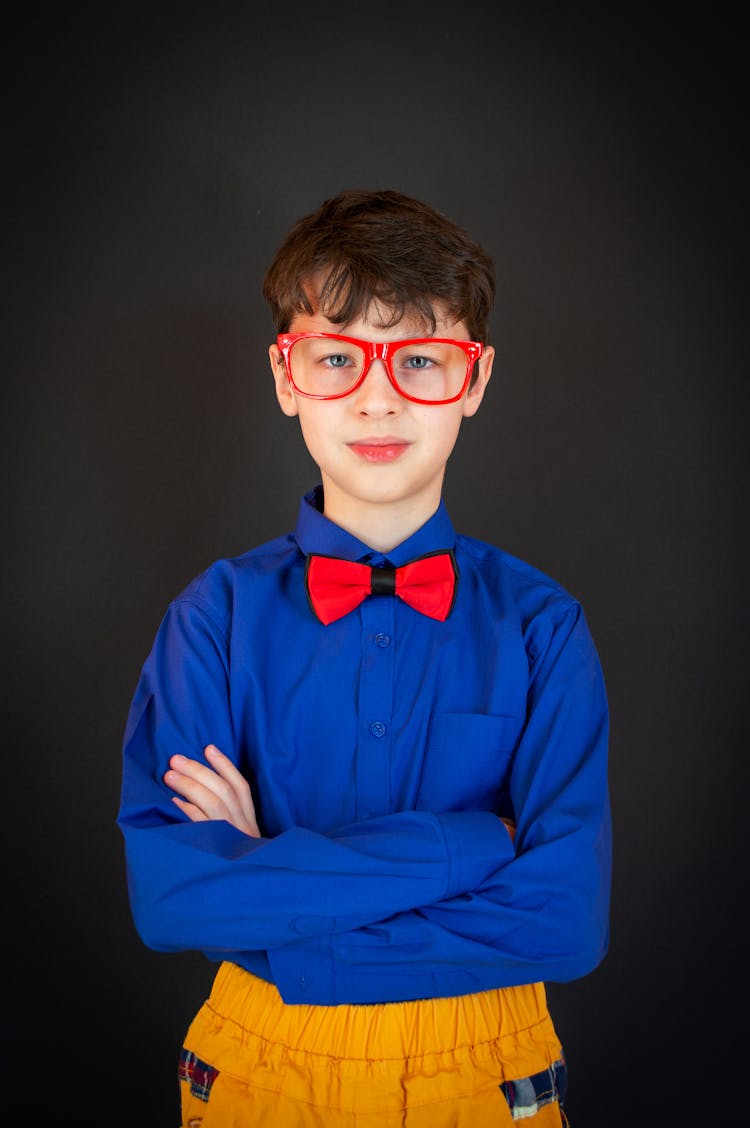 Cute Schoolboy In Glasses Looking At Camera