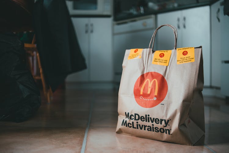 Beige Delivery Paper Bag Placed On Floor Of Kitchen