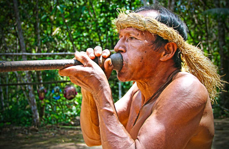 Man From A Tribe Using A Blowgun