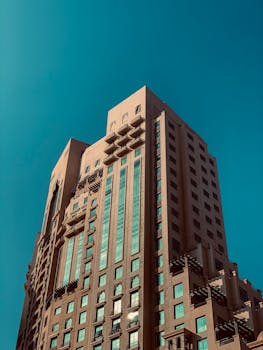 A striking modern residential building with clear blue sky in Dubai, UAE.