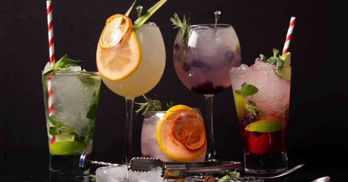 A diverse collection of colorful cocktails with garnishes, perfect for a refreshing drink experience.