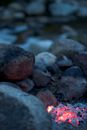 Burning Firelog Surrounded of Pebbles