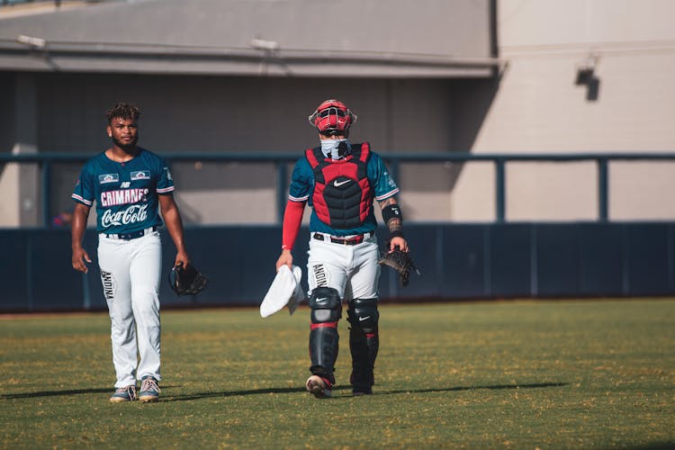 Baseball Players Walking Onto The Field