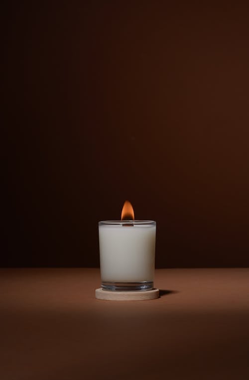 Free Burning candle on table in studio Stock Photo