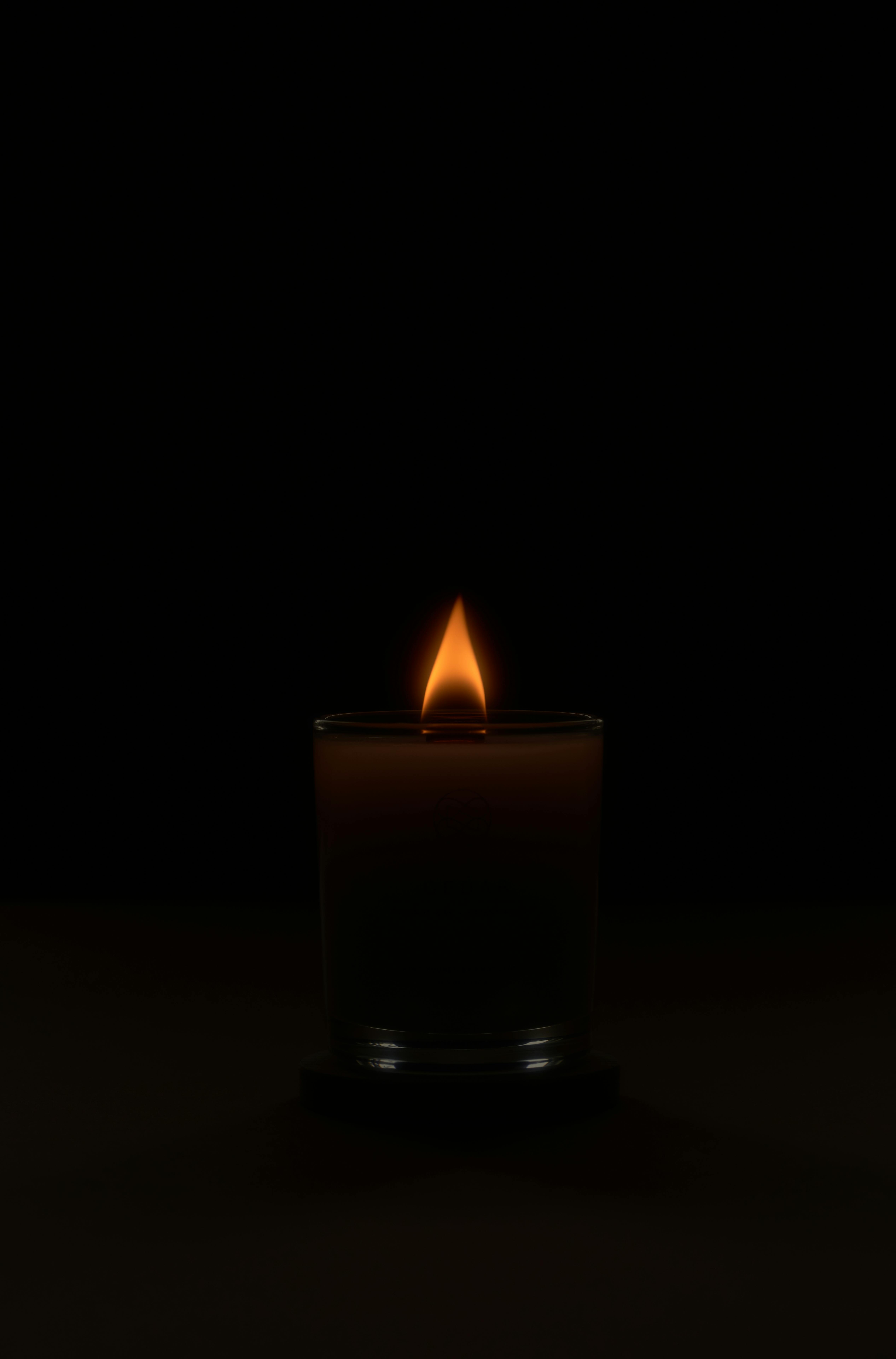 flaming candle in dark obscure studio