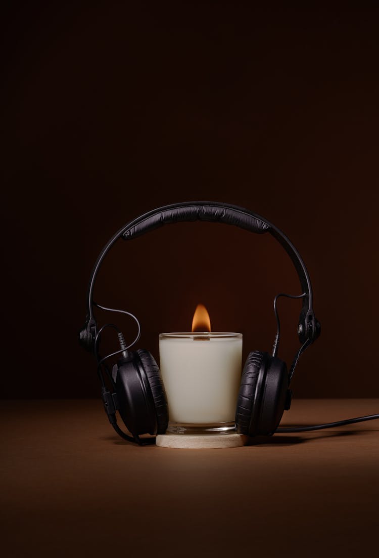 Glowing Aroma Candle With Headphones In Studio