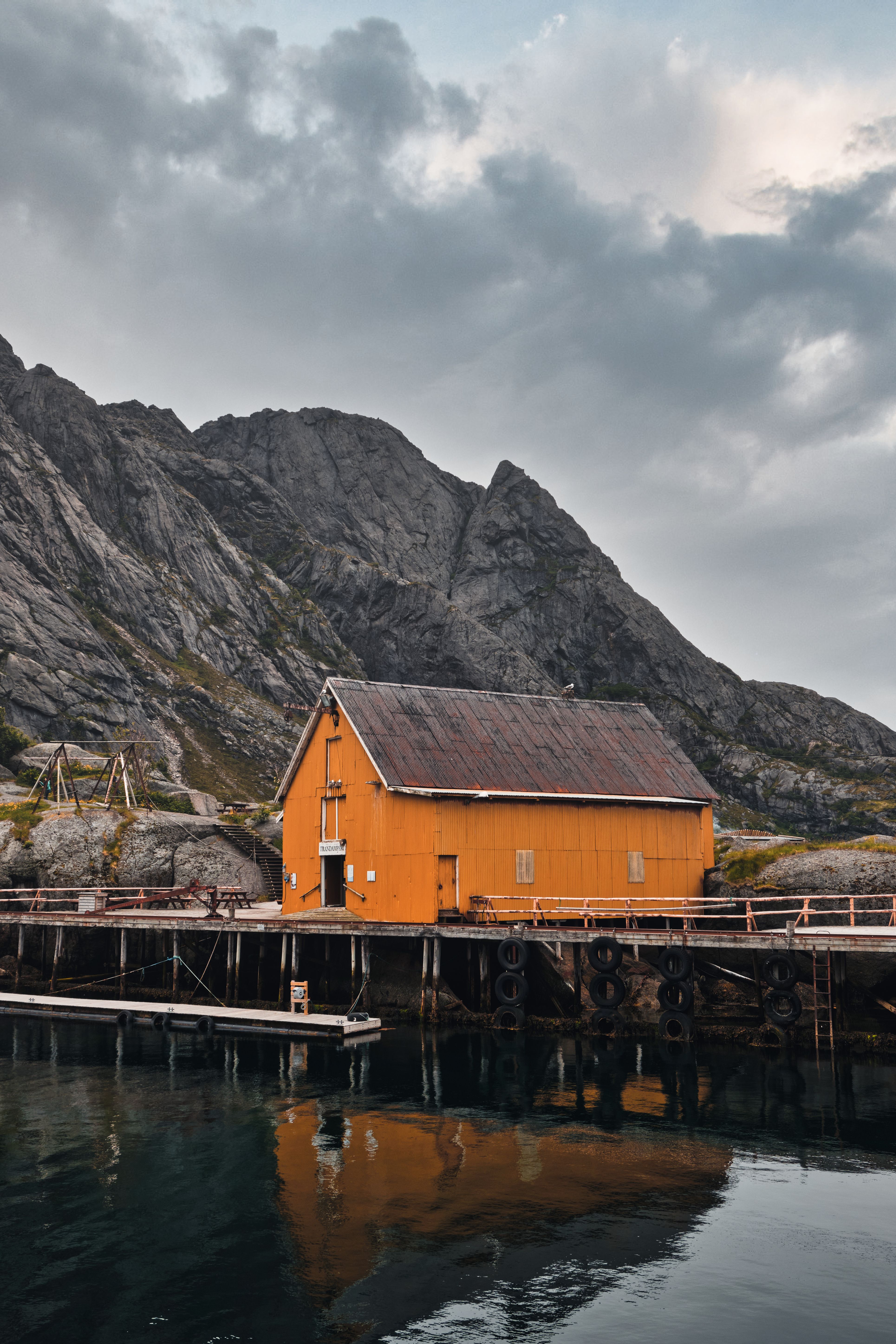 Brown Wooden House on Dock Near Mountain · Free Stock Photo
