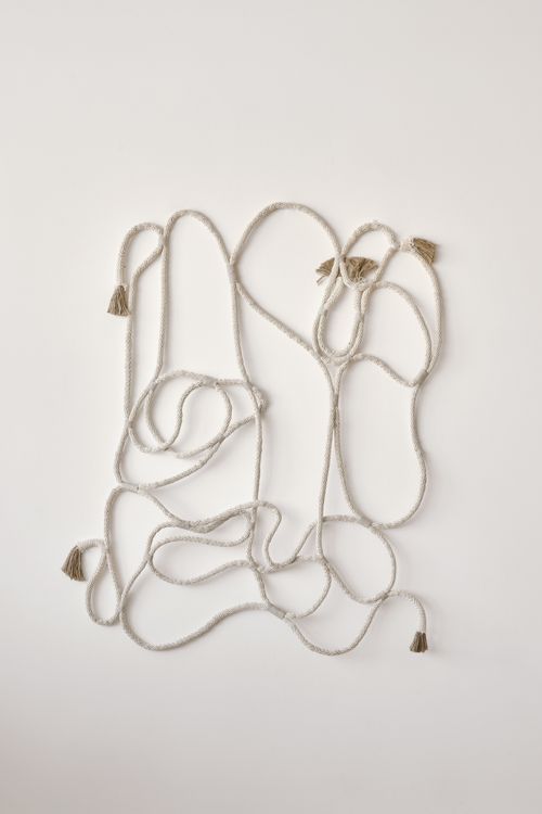 Decorative creative rope hanging on wall · Free Stock Photo