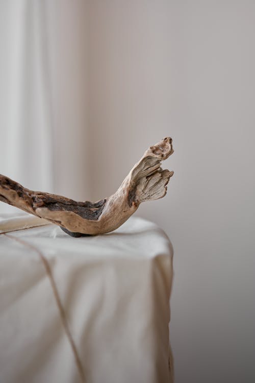 Wooden driftwood on pedestal wrapped with fabric