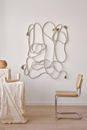Minimalist decor with pedestals under cloth near chair