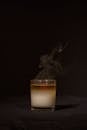 Transparent glass holder with aromatic candle with fume for relaxation against dark black background