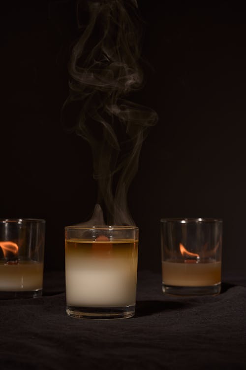 Transparent burning wax aroma candles in studio