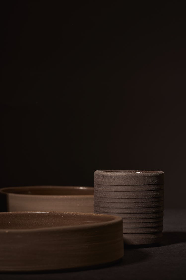 Round Ceramic Dishes Placed On Black Surface