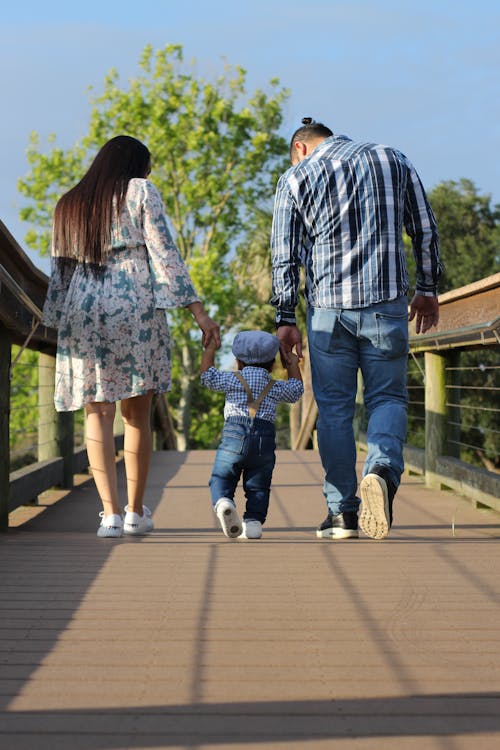 Free Man and Woman Holding Childs Hand Stock Photo