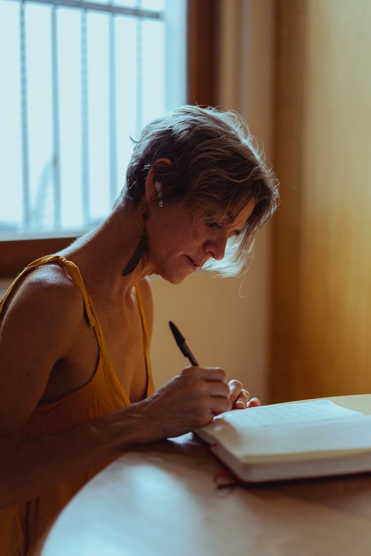 Elderly Woman Busy Writing