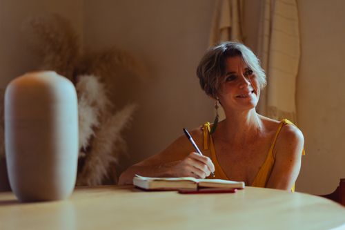 Free A senior woman is writing in her journal at home, enjoying a peaceful and reflective moment. Stock Photo