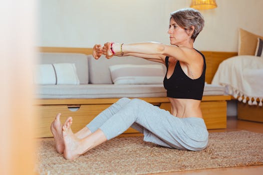Elderly woman in a yoga pose indoors, embracing healthy lifestyle and wellness.