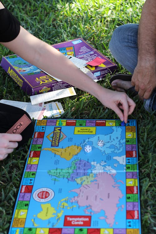 People Playing Board Game on Grass