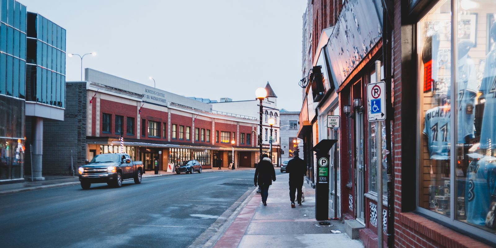 A lively downtown street with storefronts