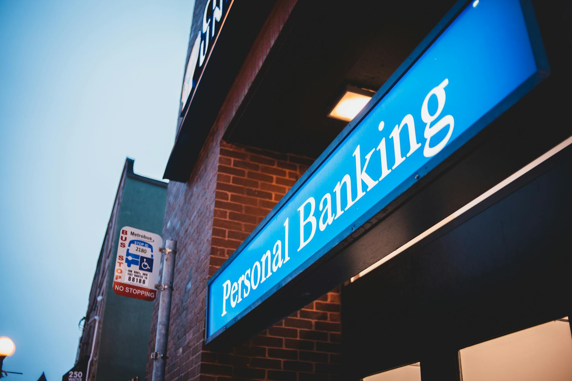 From below of bright blue signboard saying personal banking on modern building of town