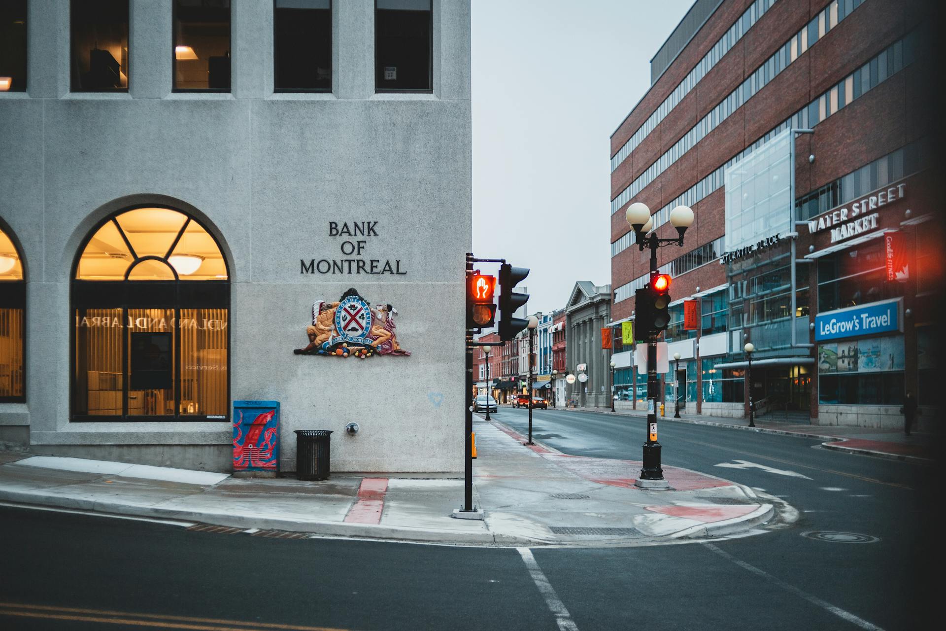 Street scene featuring the Bank of Montreal in a modern urban setting with traffic lights and architecture.