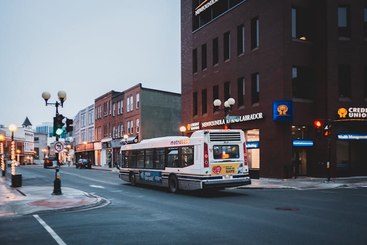 City Street With Bus Driving On Asphalt Road