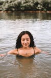 Free Cheerful woman swimming in river Stock Photo