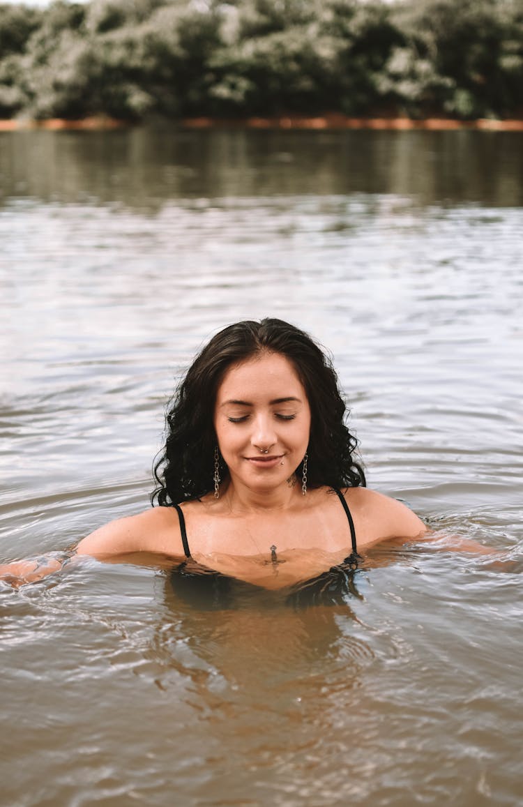 Cheerful Woman Swimming In River