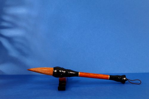Free Close-up of a traditional calligraphy brush against a blue background with ample copy space. Stock Photo