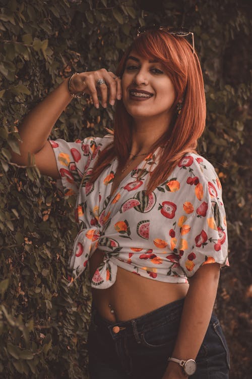 Photo of a Woman with Red Hair Smiling at the Camera