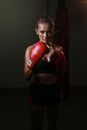 Woman Wearing Red Boxing Gloves Sweating on the Gym