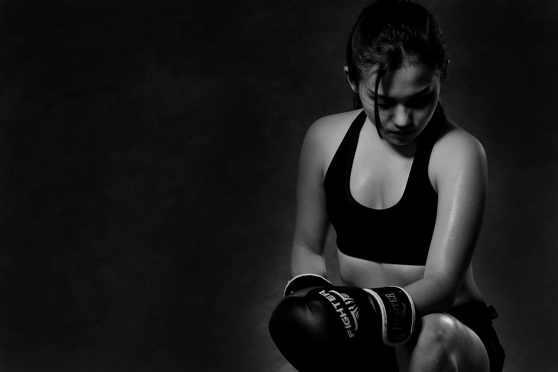 Man in Black Tank Top Wearing Black Boxing Gloves