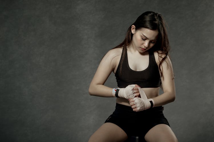 Woman Wearing Sports Bra Wrapping Her Hands