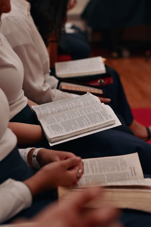 Close up of People Sitting with Books