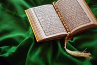 White Book Page on Green Textile