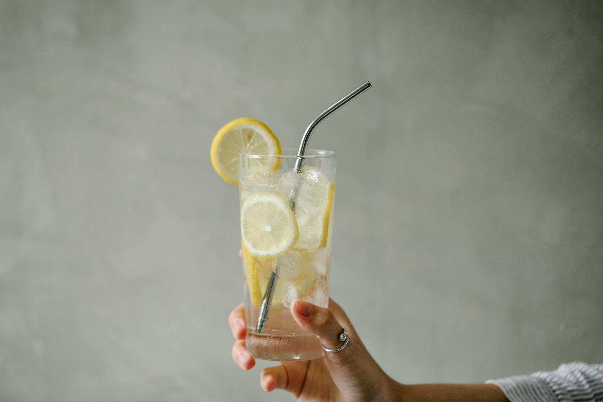 Crop woman with glass of lemonade