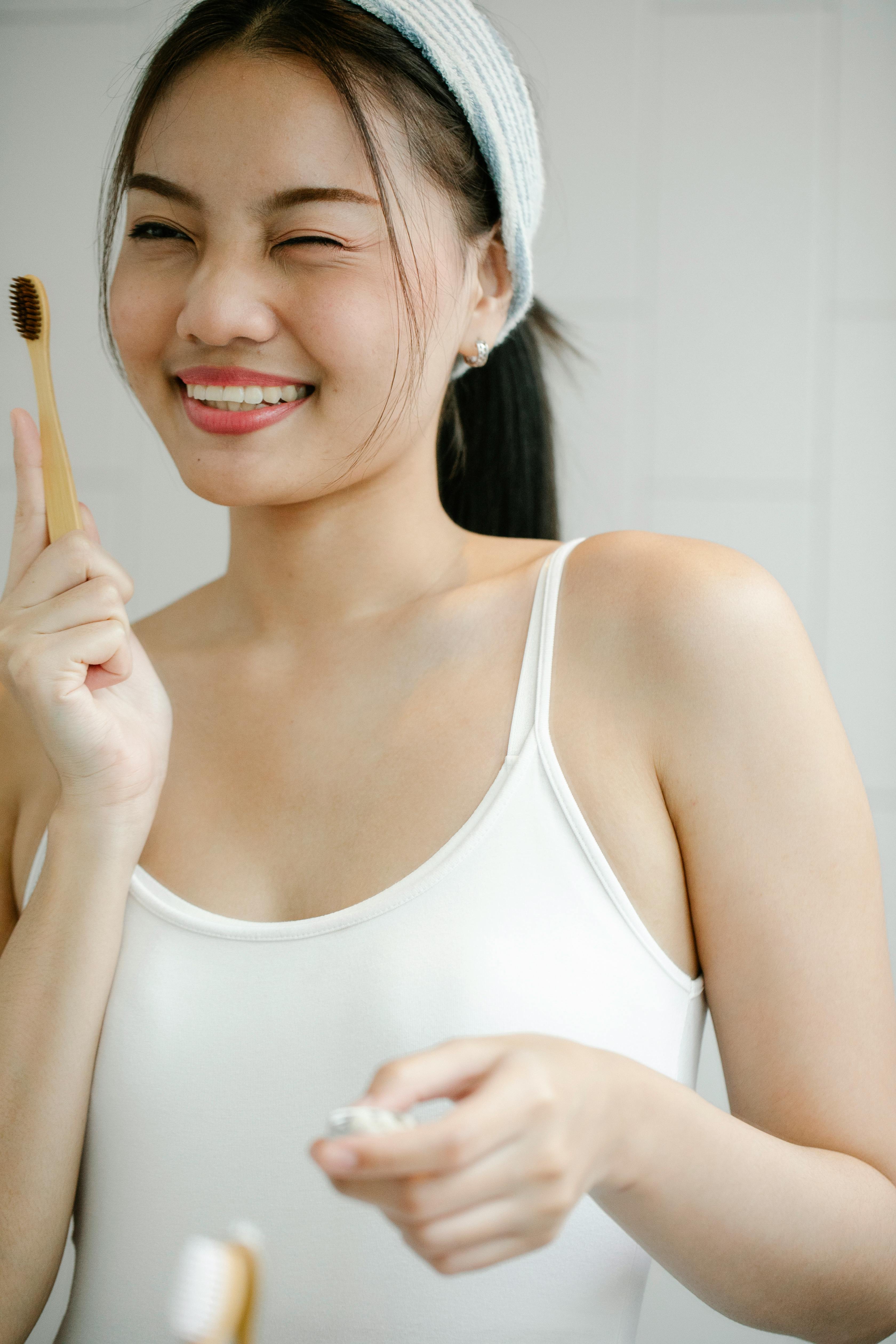 happy asian woman with toothbrush