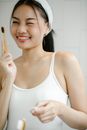 Happy Asian woman with toothbrush