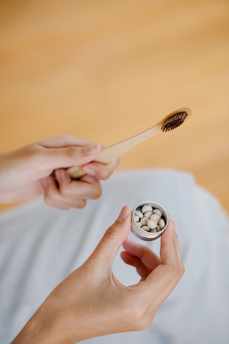 Crop Woman With Toothbrush And Toothpaste Tablets