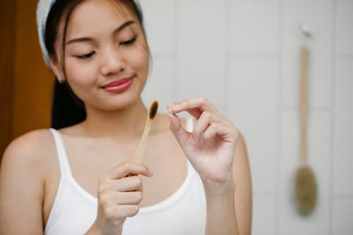 Free Smiling Asian woman with toothbrush Stock Photo