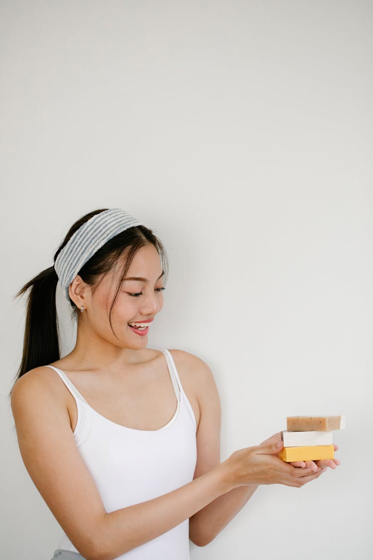 Cheerful Asian Woman With Natural Soap Bars