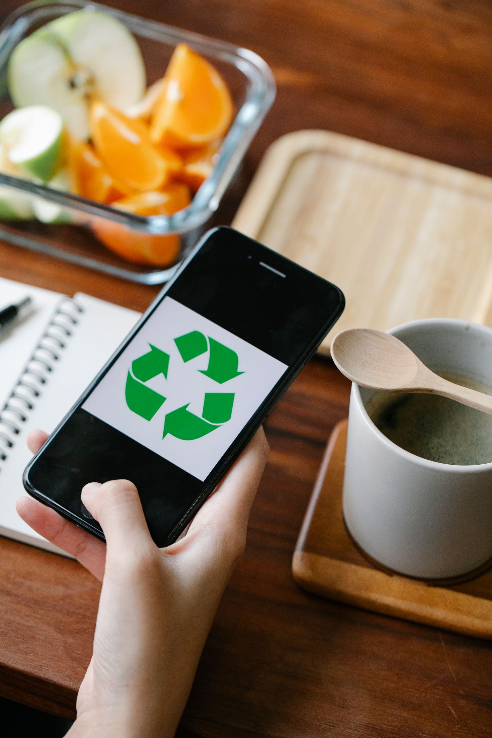A person exploring recycling and sustainable living on a smartphone
