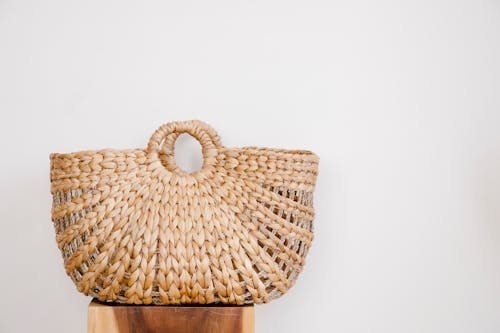 Yellow wicker bag on stand